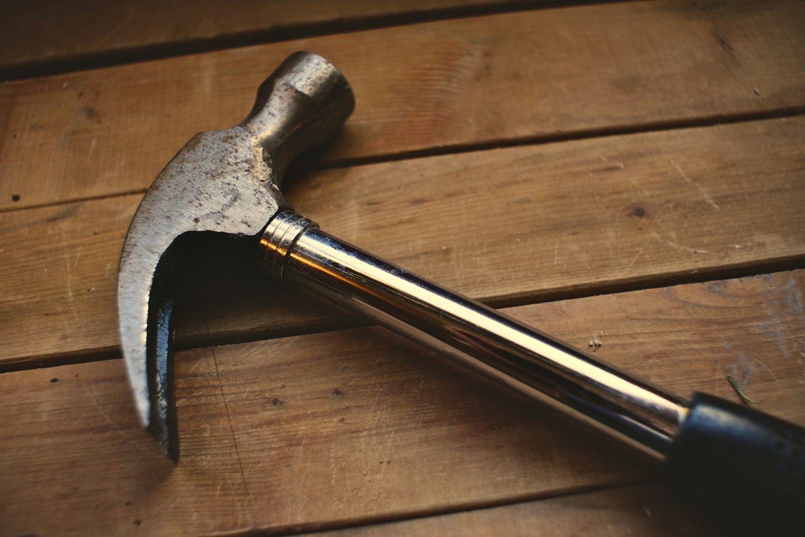 Claw hammer resting on wooden boards